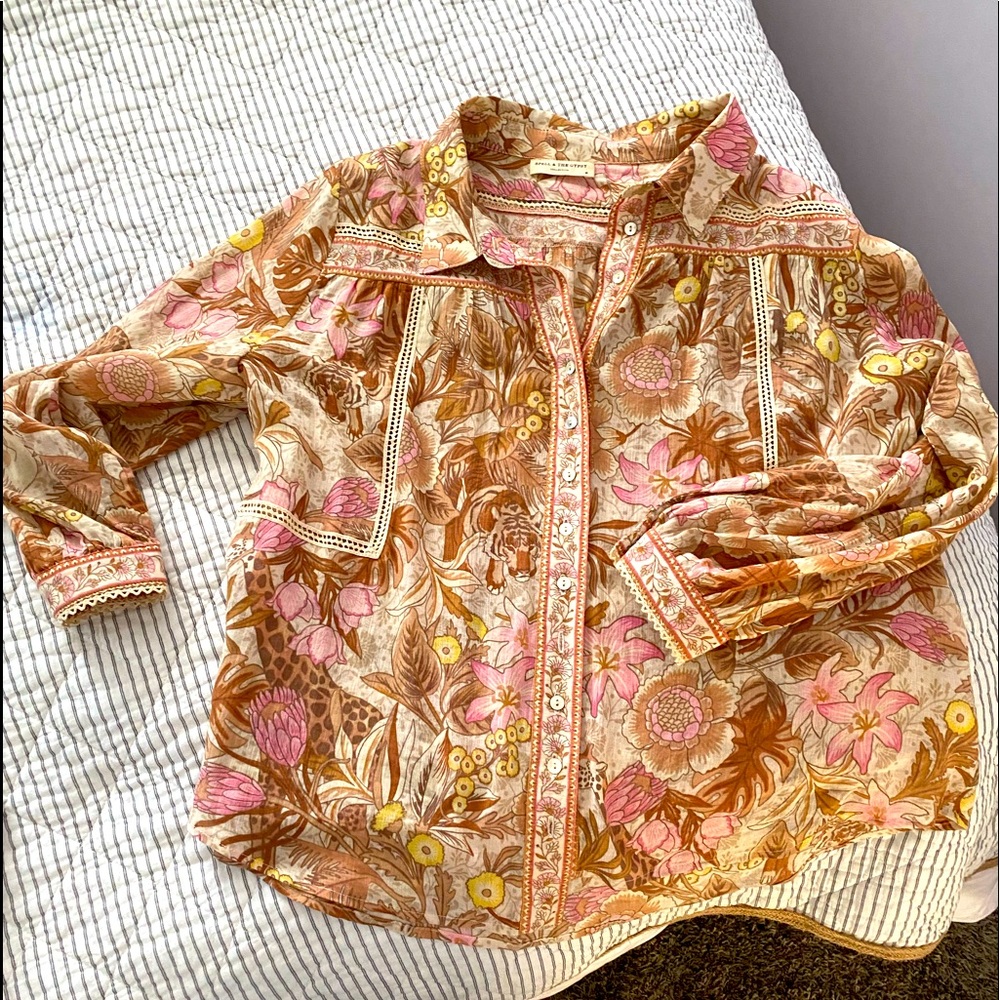 This is a practically new without tags spell top. It’s beautiful.